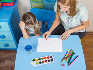 Image showing Mentor and five year old girl at the table draw a picture in kindergarten