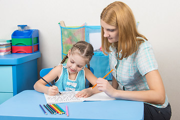 Image showing The young girl engaged in a five year old girl spelling