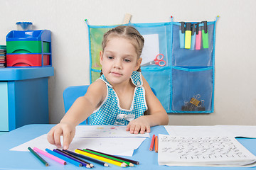 Image showing Five-year girl choose the right pencil doing painting