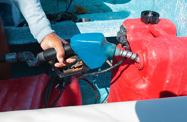 Image showing Man fueling tank of a motor boat before travel