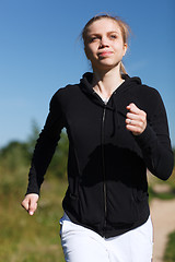 Image showing Girl running in the park. Close up