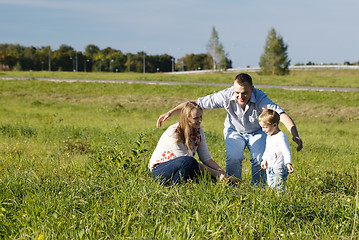 Image showing Protective father playing with his wife and son