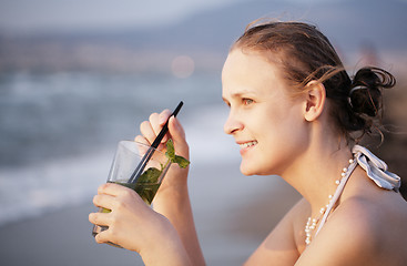 Image showing Woman enjoying an evening cocktail