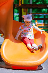 Image showing Small girl having fun on a slide