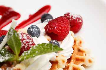 Image showing Waffle and cream topped with fresh berries