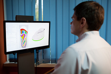 Image showing Orthopaedist at work with digital footstep model