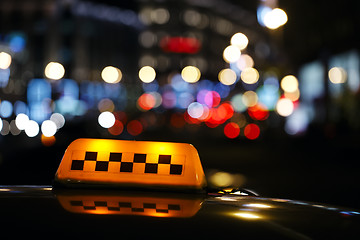 Image showing Illuminated taxi cab sign on a city street