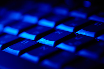 Image showing Computer keyboard in blue light.