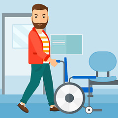 Image showing Man pushing wheelchair.