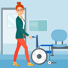 Image showing Woman pushing wheelchair.