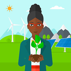 Image showing Woman holding plant.