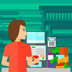 Image showing Cashier at supermarket checkout.