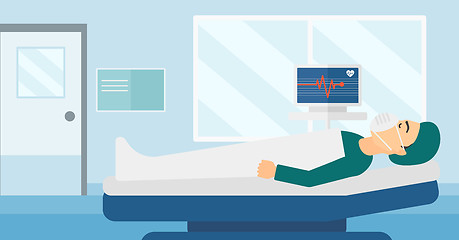 Image showing Patient lying in hospital bed with heart monitor.