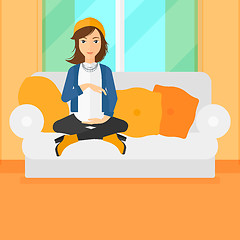 Image showing Pregnant woman sitting on sofa.