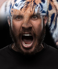 Image showing Portrait of young screaming man as tiger