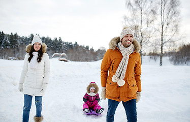 Image showing happy family with sled walking in winter outdoors