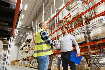 Image showing worker and businessmen with clipboard at warehouse