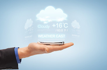 Image showing male hand with smartphone and weather cast