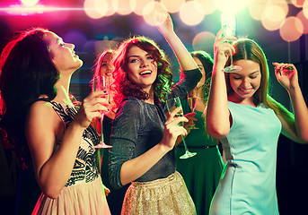 Image showing smiling friends with glasses of champagne in club