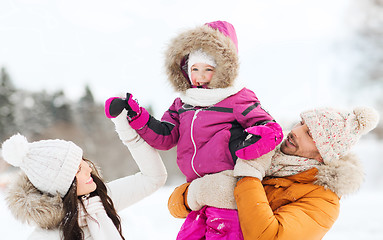 Image showing happy family with child in winter clothes outdoors