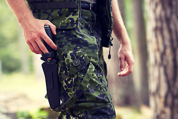 Image showing close up of soldier or hunter with knife in forest