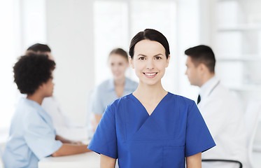 Image showing happy doctor over group of medics at hospital