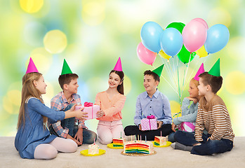 Image showing happy children giving presents at birthday party