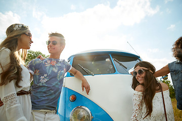 Image showing smiling young hippie friends over minivan car