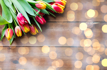 Image showing close up of tulip flowers on wooden table