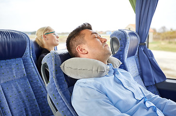 Image showing man sleeping in travel bus with cervical pillow
