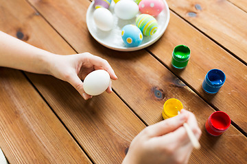 Image showing close up of woman hands coloring easter eggs