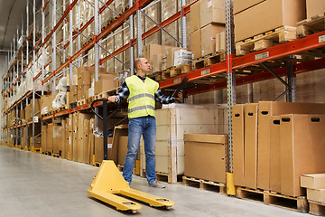 Image showing man with loader and clipboard at warehouse