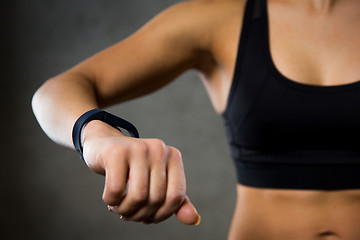 Image showing woman with heart-rate watch in gym