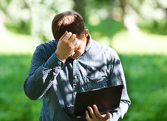 Image showing Middle-aged man with laptop