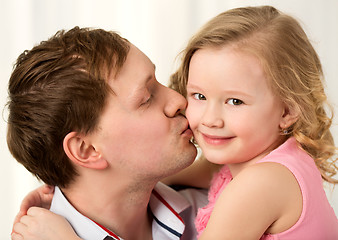 Image showing Daddy kissing beautiful little daughter