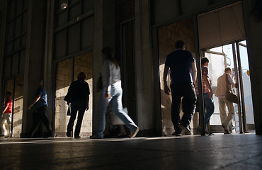 Image showing Shoppers entering and leaving a store