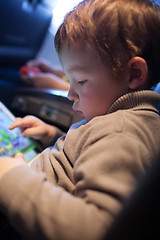 Image showing Little boy playing on a tablet computer