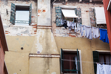 Image showing Old grungy building with linen outside