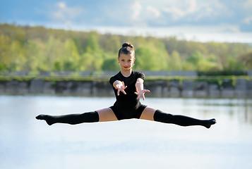 Image showing Young Gymnast is Up in the Air Doing Leg-Split