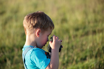 Image showing Little boy with camera outdoor