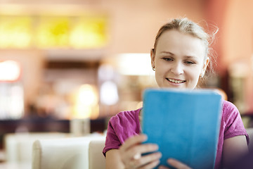 Image showing Young happy woman in cafe with tablet PC