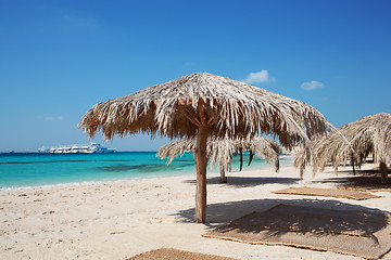 Image showing Straw beach umbrellas at a tropical resort