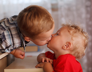 Image showing Cute siblings. Two little brothers are kissing.