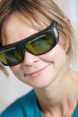 Image showing Smiling therapist in protective goggles