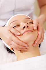 Image showing Woman in the beauty spa getting a facial massage