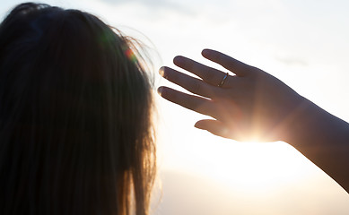 Image showing Woman hiding from the sun with hand