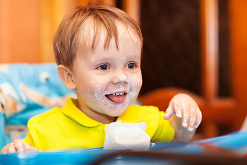 Image showing Happy child dirty with cream yoghurt