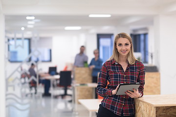 Image showing portrait of young business woman at office with team in backgrou