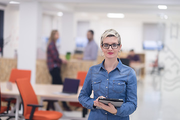 Image showing portrait of young business woman at office with team in backgrou