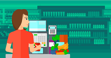 Image showing Cashier at supermarket checkout.